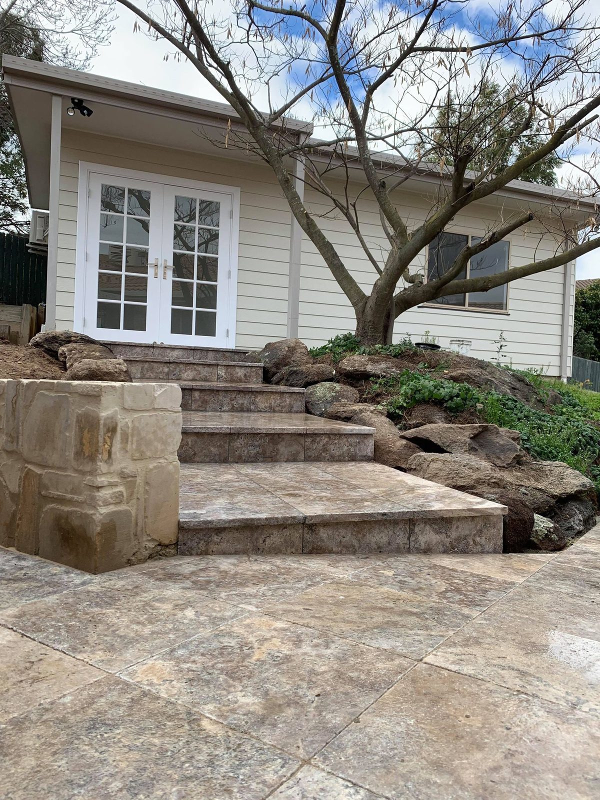 Sandstone steps and paved entry