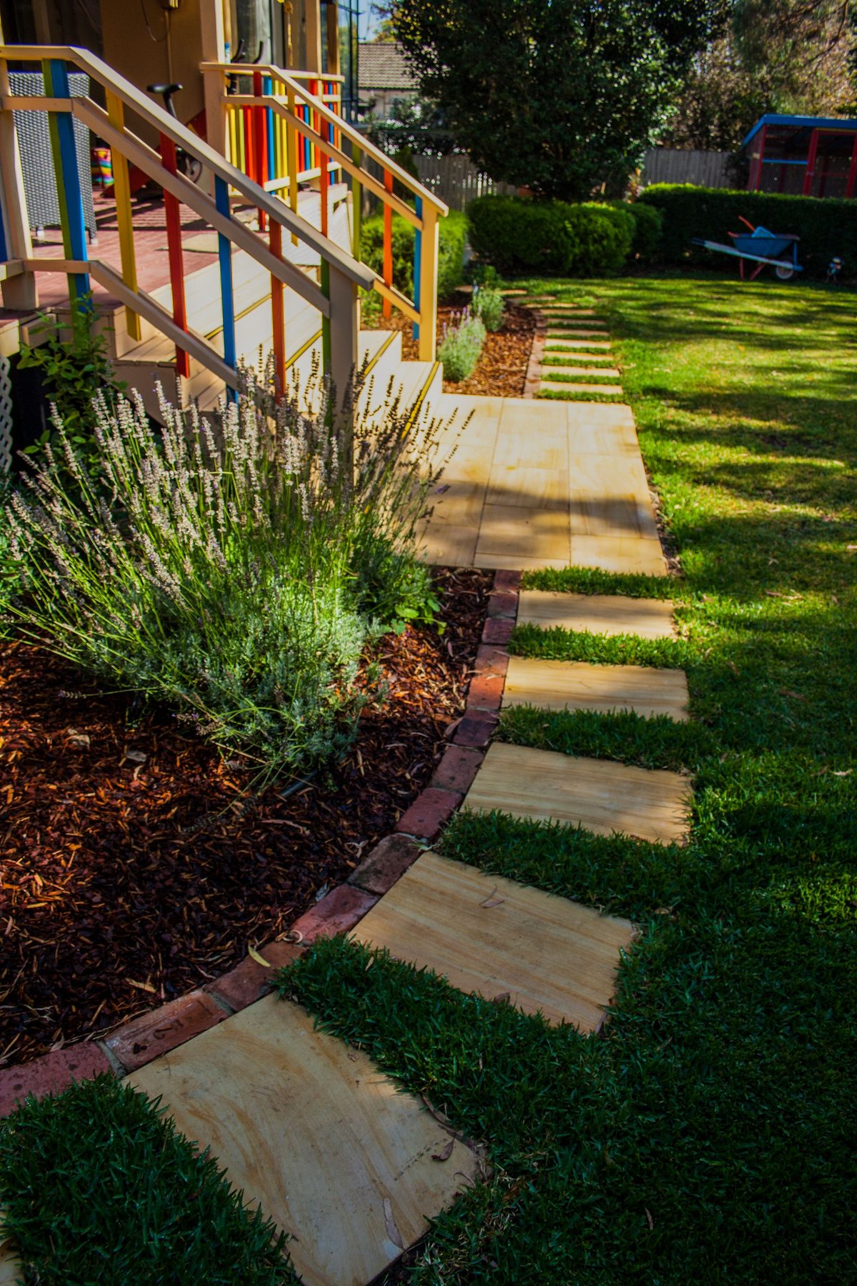 Stepping stone path through lawn and garden beds